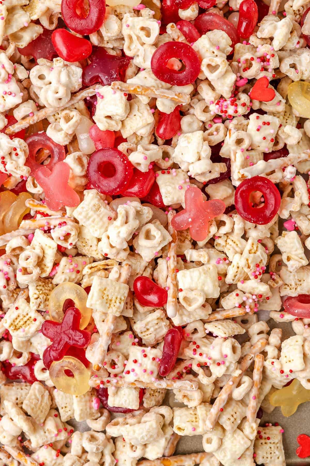 A close image of pink, red, and white Valentine snack mix.