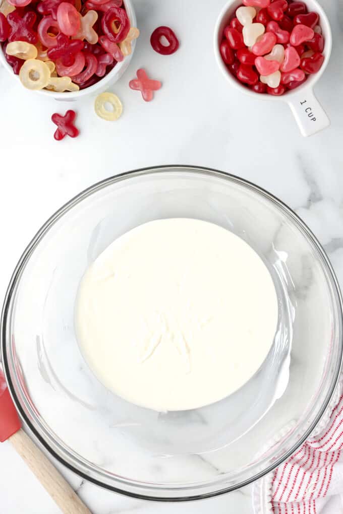 Melted white chocolate in a large glass bowl.