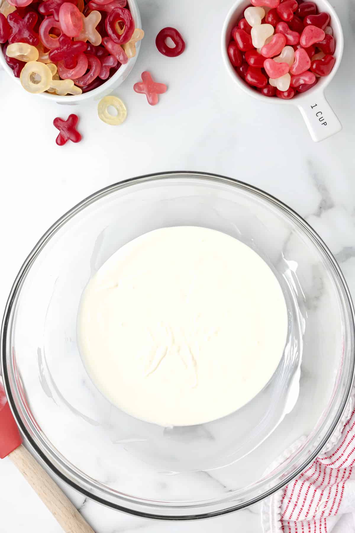 Melted white chocolate in a large glass bowl.