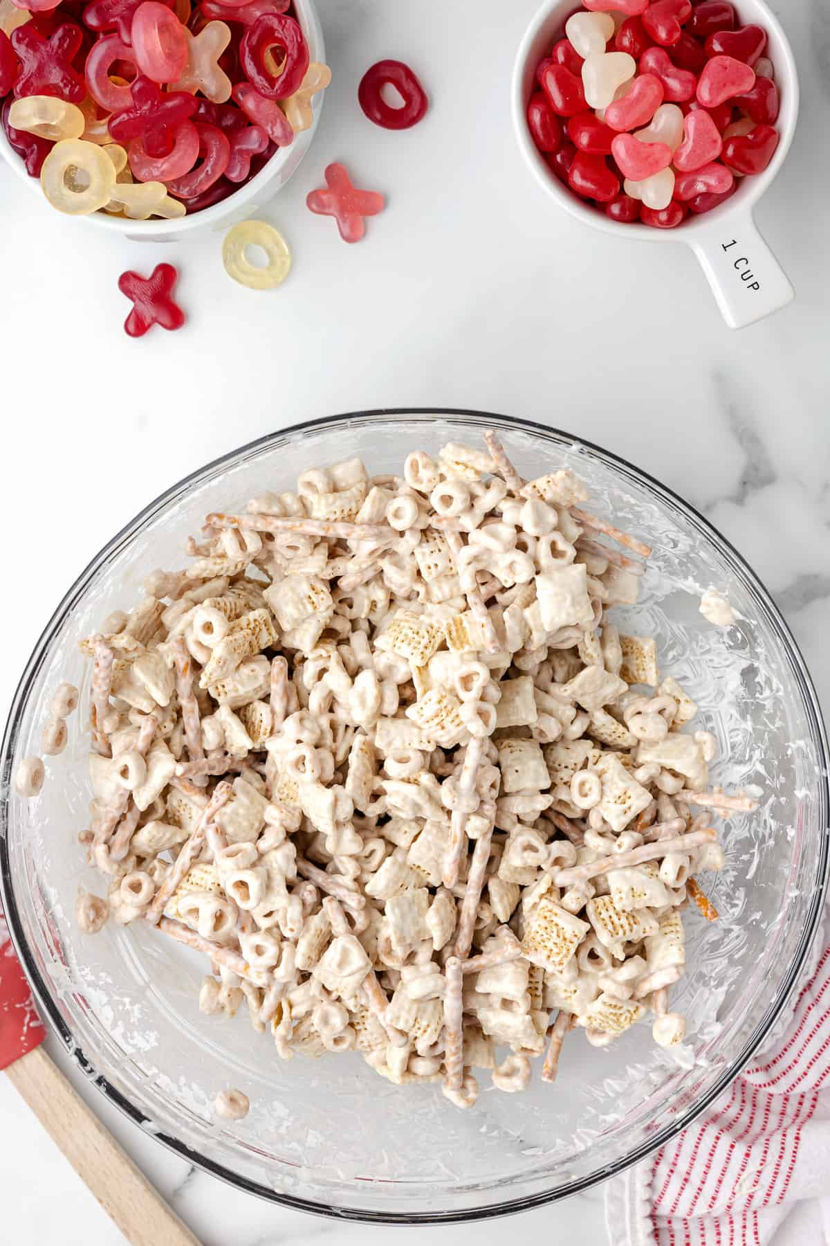 Cereal and pretzels in a bowl coated with melted white chocolate.