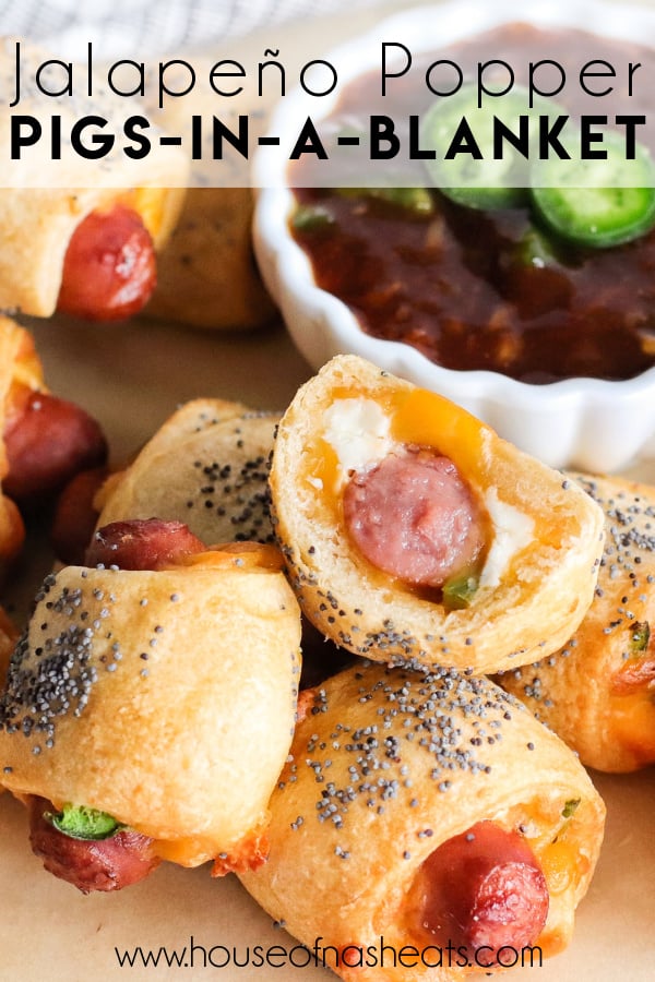 Jalapeno popper pigs in a blanket in a pile next to a bowl of dipping sauce with text overlay.