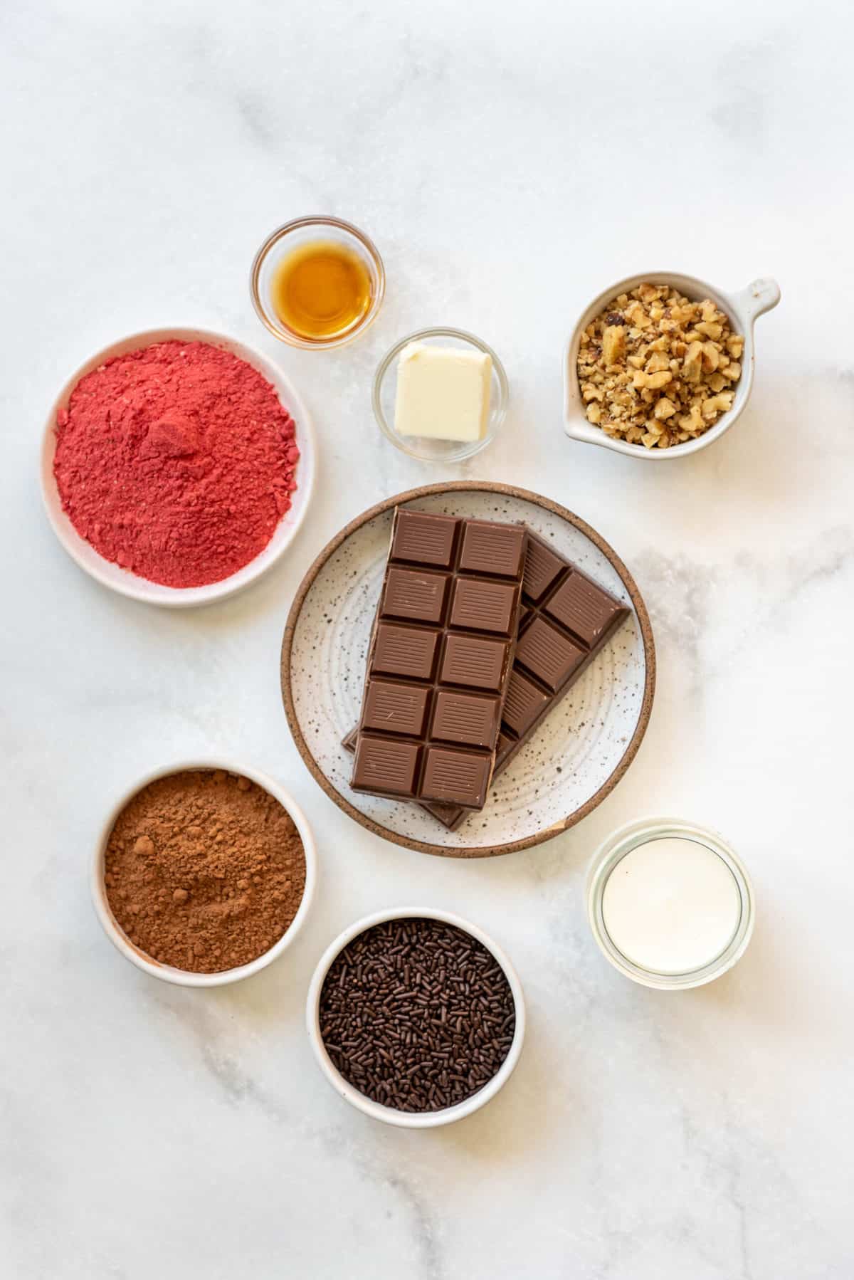 Ingredients for chocolate truffles on a white surface.
