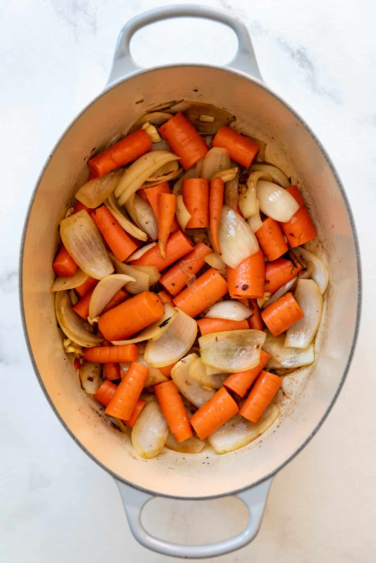 Sauteeing carrots and onions in a Dutch oven.