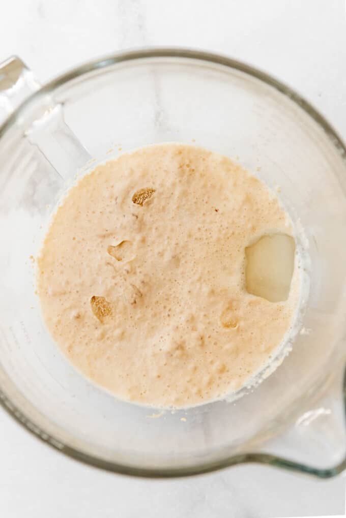 Proofed yeast in a glass mixing bowl.