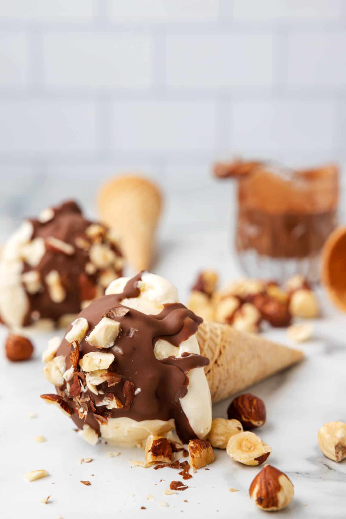 Chocolate hazelnut magic shell on vanilla ice cream in sugar cones.