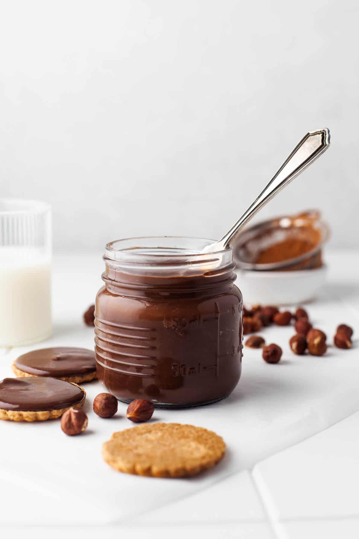 A jar of homemade nutella with a knife in it.