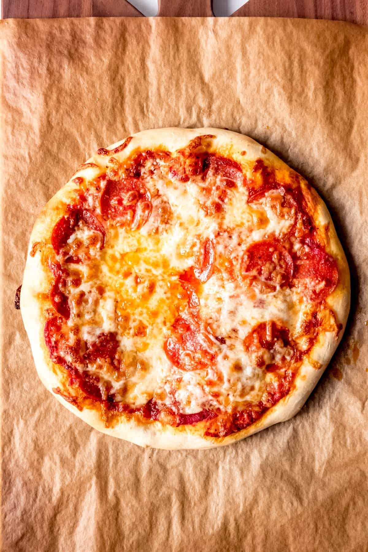 An image of a homemade pizza with melted cheese and pepperoni on top.