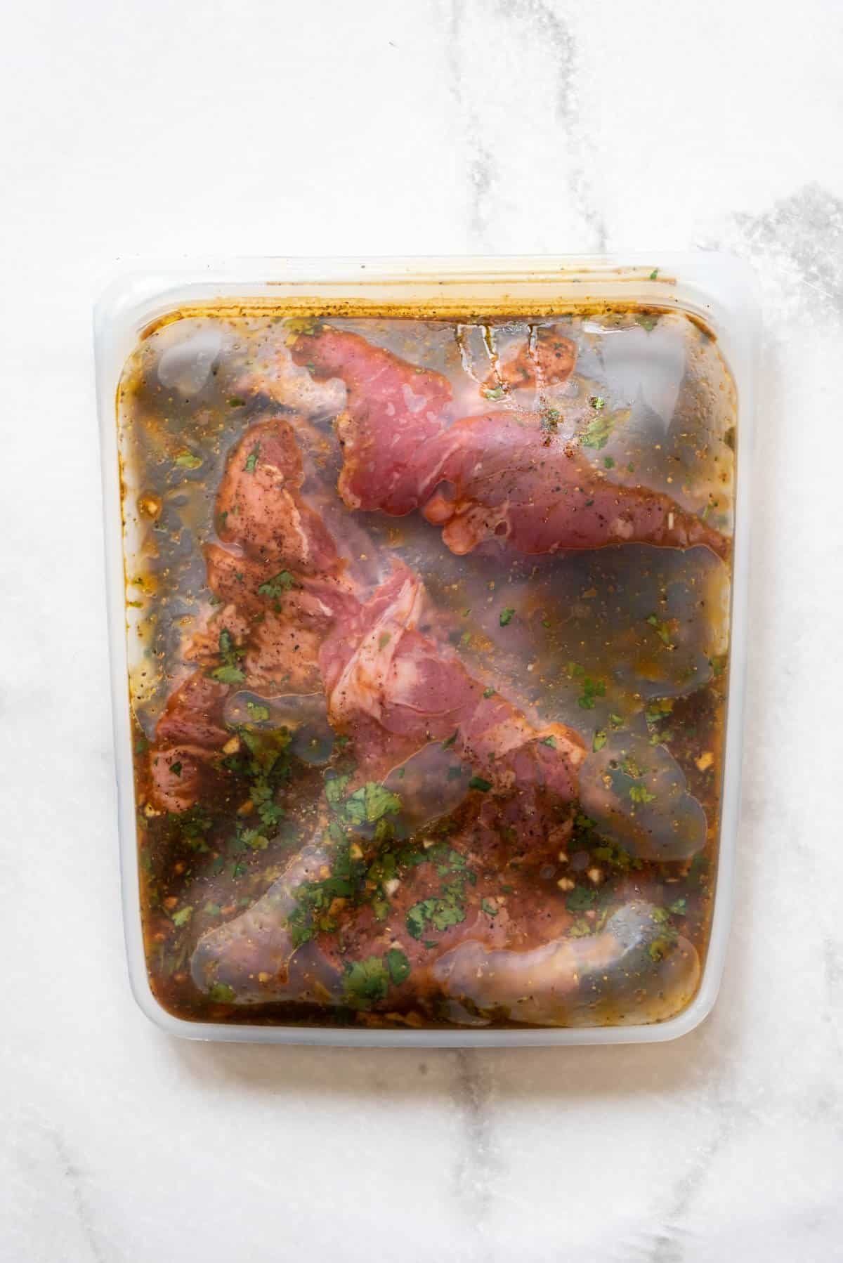 Marinating skirt steak for fajitas in a resealable silicon bag.