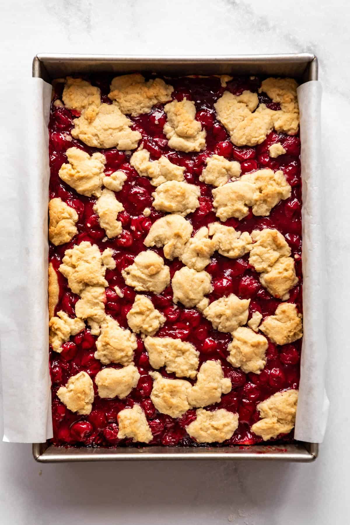 Baked cherry pie cookie bars in a baking dish.