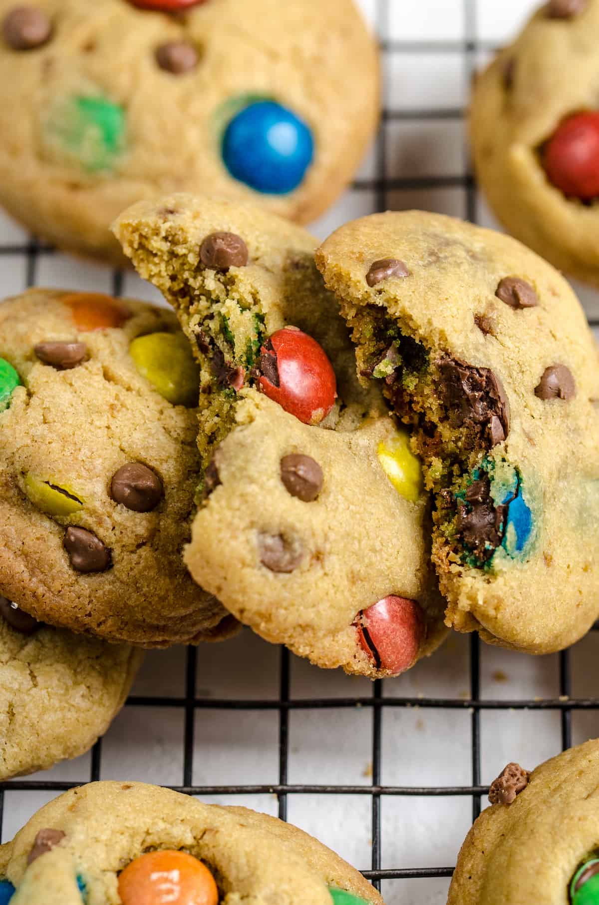 A close-up shot of two M&M cookies with a bite taken out of each one