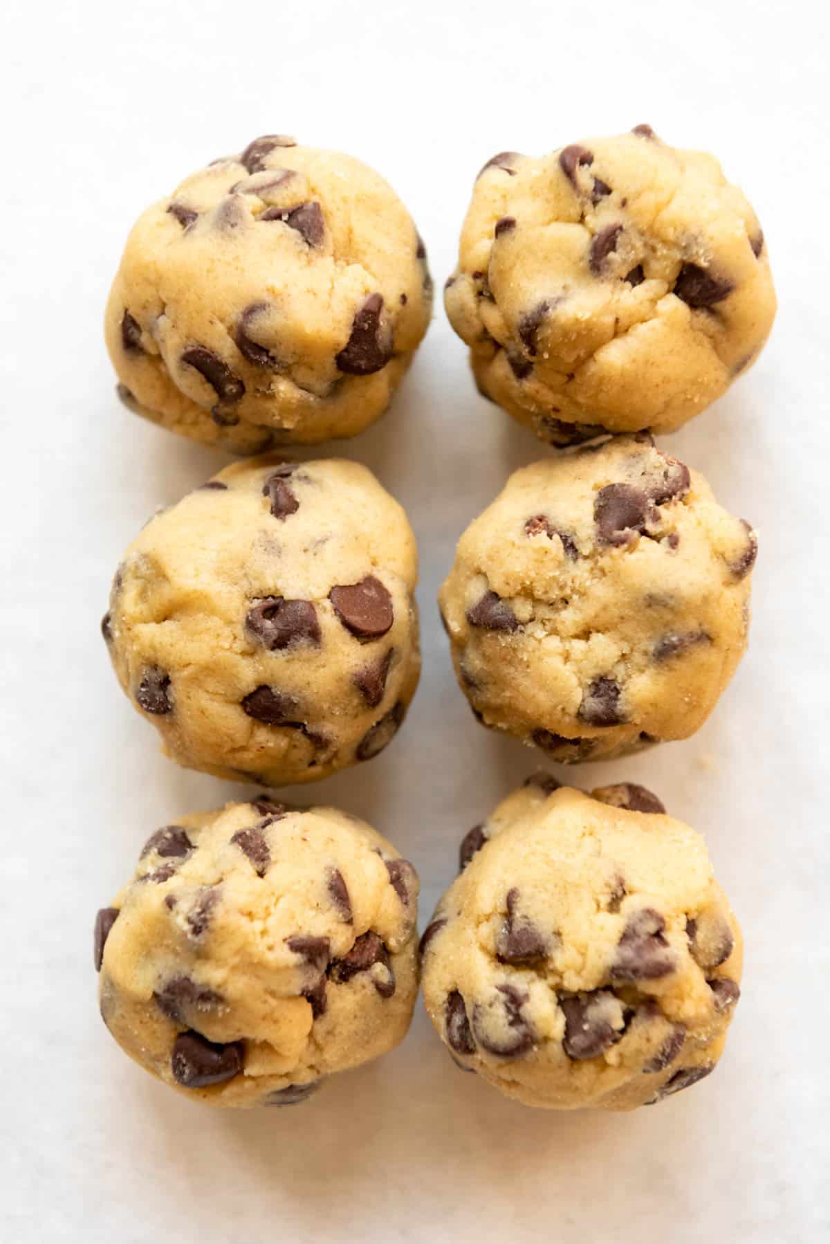 Six balls of homemade chocolate chip cookie dough.