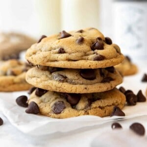 A stack of three chocolate chip cookies.