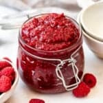 A jar of homemade raspberry cake filling.