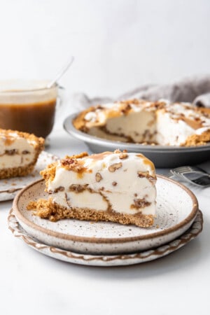 A slice of butter pecan ice cream pie with a butterscotch swirl.