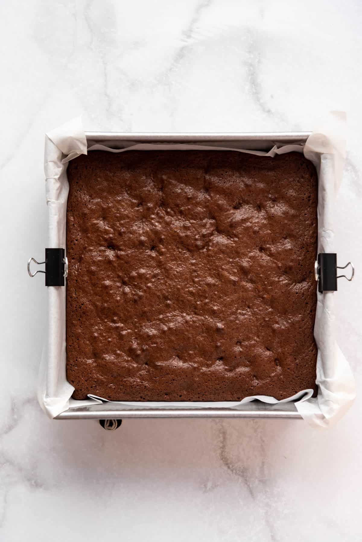Homemade brownies in a square baking pan.