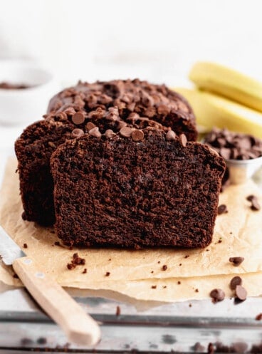 Moist chocolate banana bread on parchment paper.