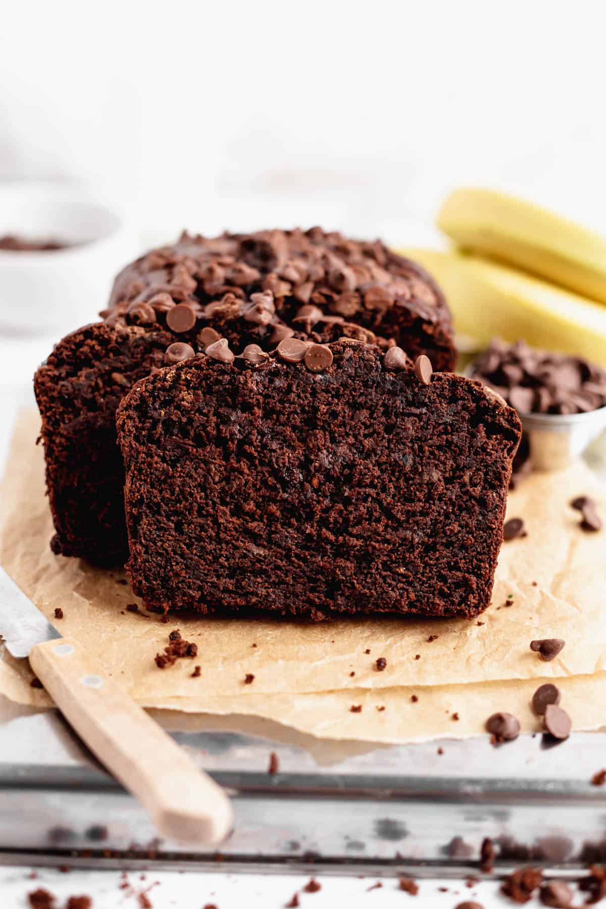 Moist chocolate banana bread on parchment paper.
