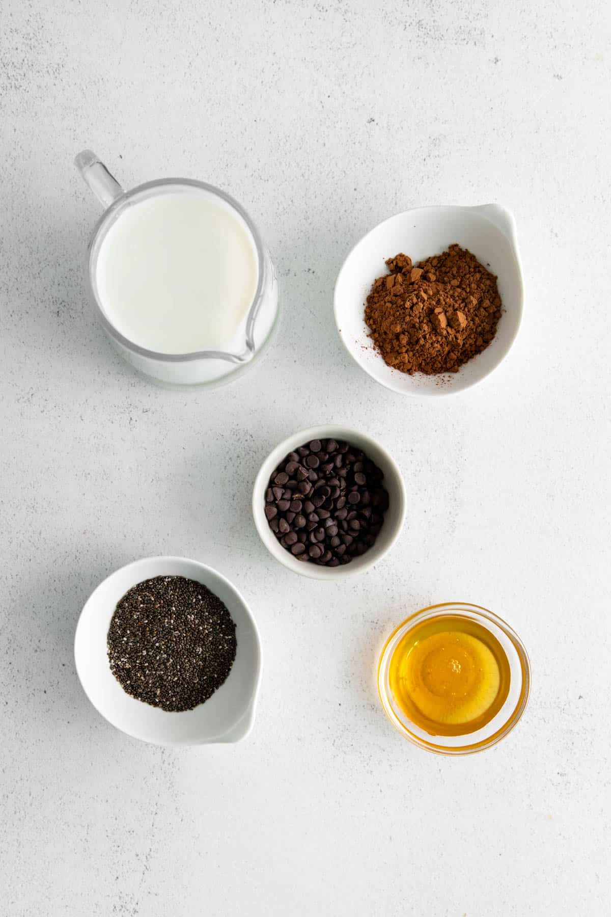 Chocolate chia pudding ingredients in separate bowls.