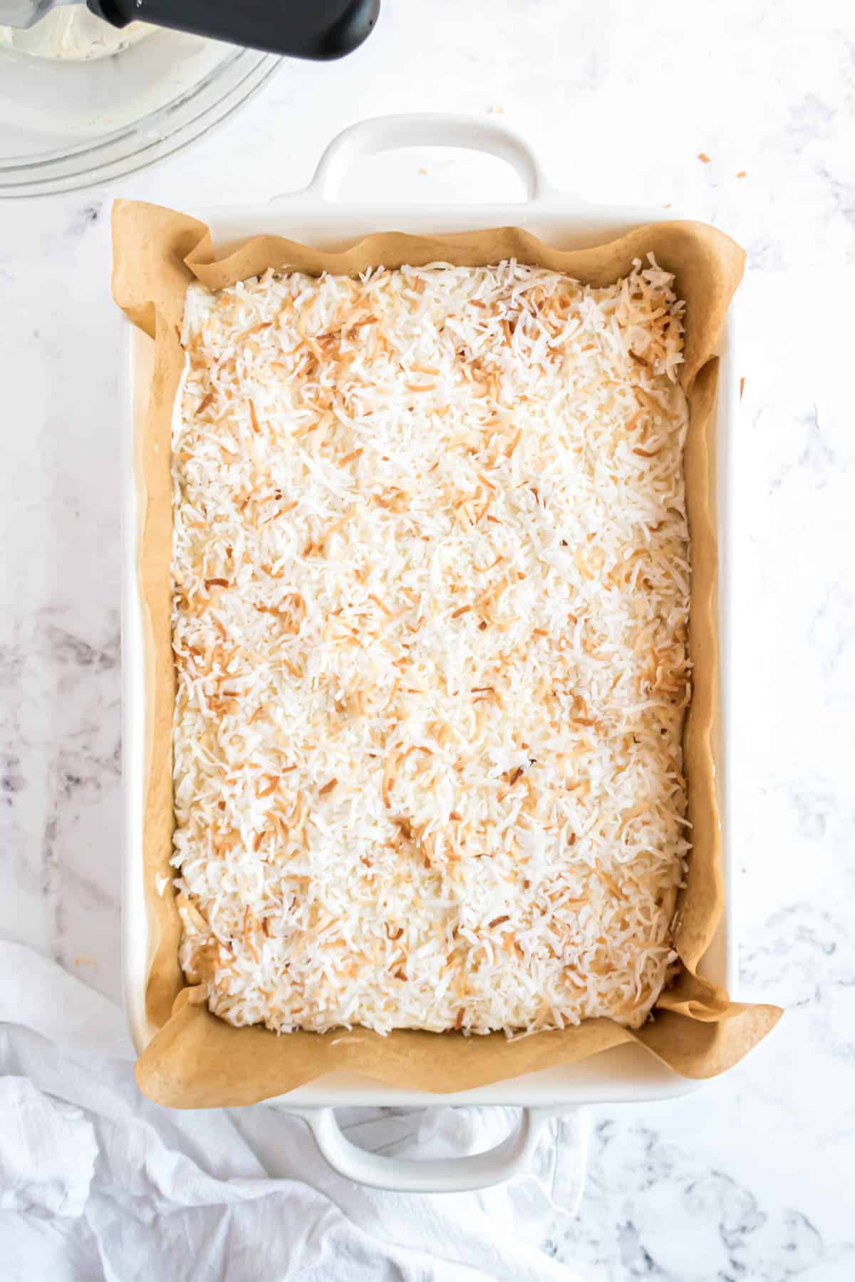 Coconut sugar cookie bars in a baking dish.