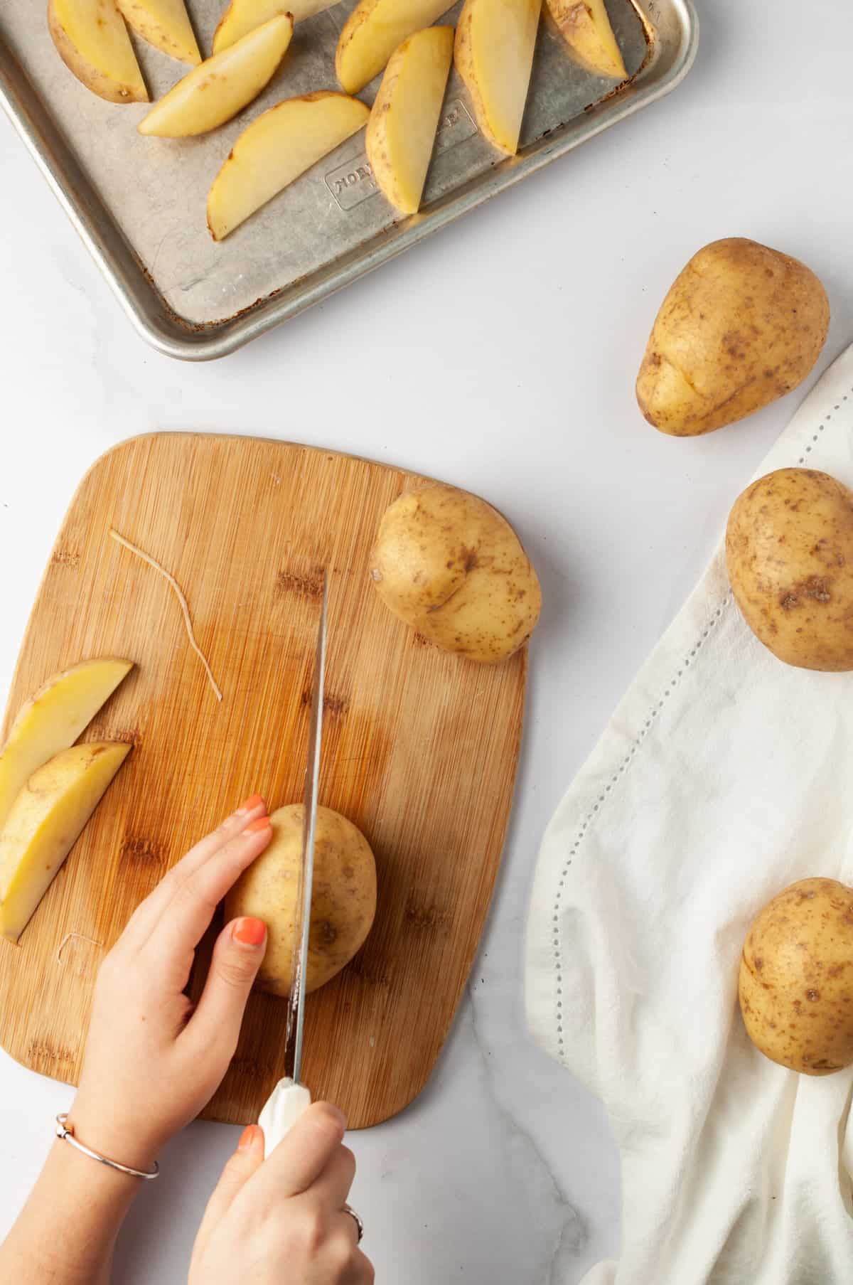 Cutting a potato in half with a chef's knife