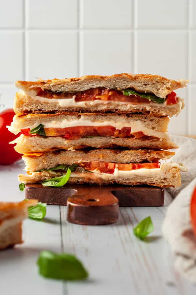 Stack of 3 caprese paninis on board