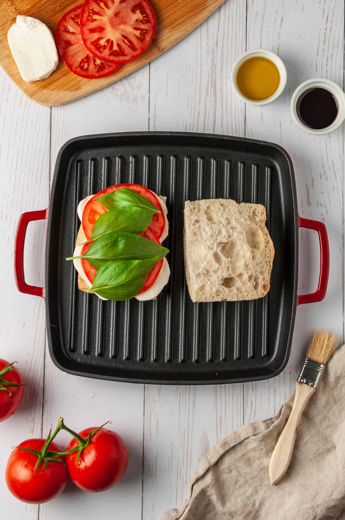 Assembling caprese panini on grill pan
