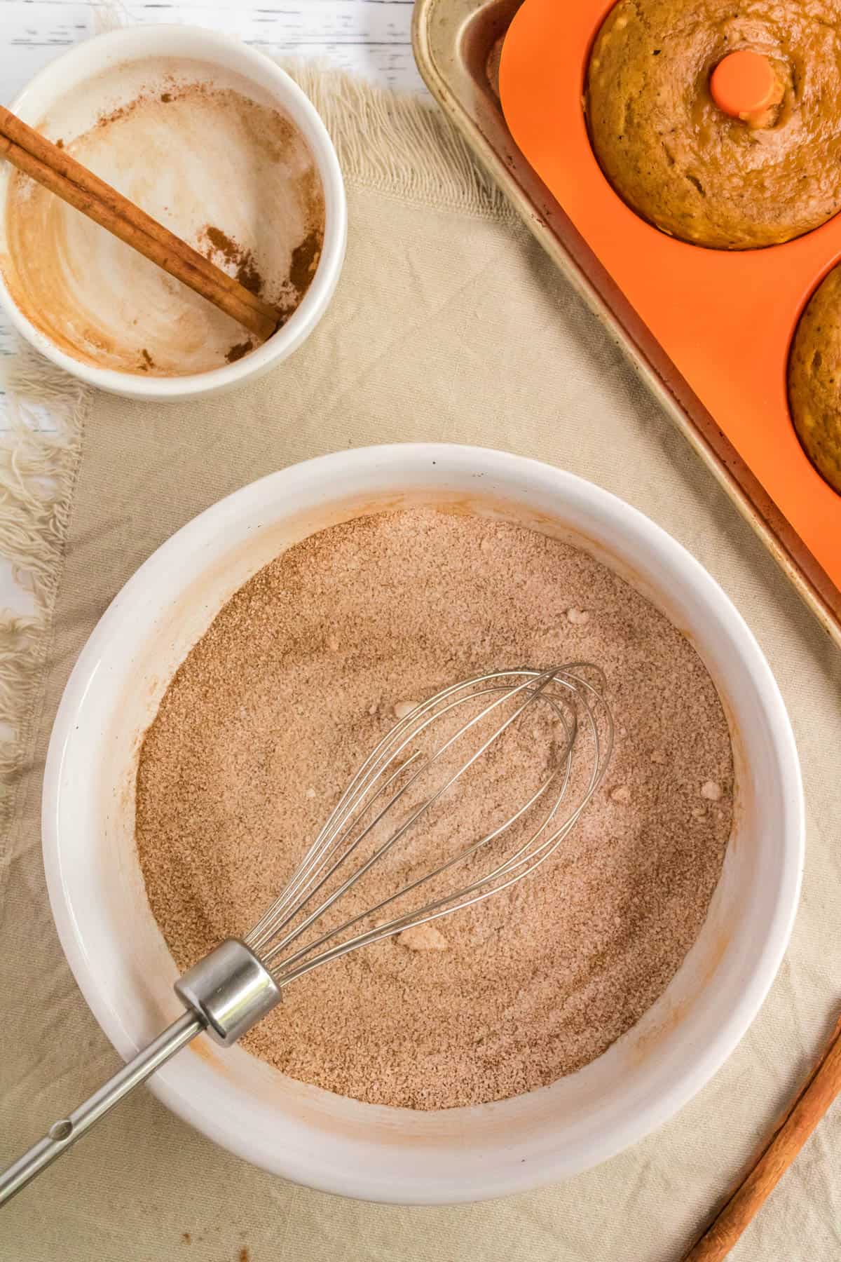Mixing cinnamon and sugar in a bowl.