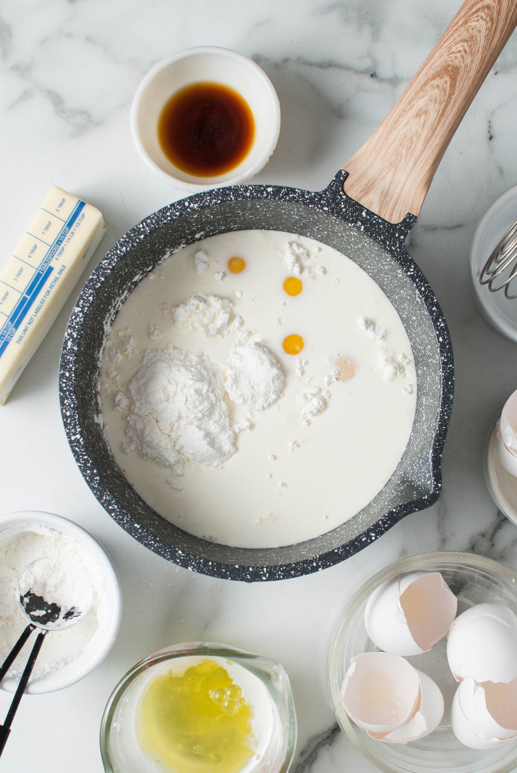 Combining milk, cornstarch, and egg yolks in a saucepan.