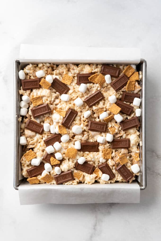 S'mores rice krispie treats in a pan lined with parchment paper.