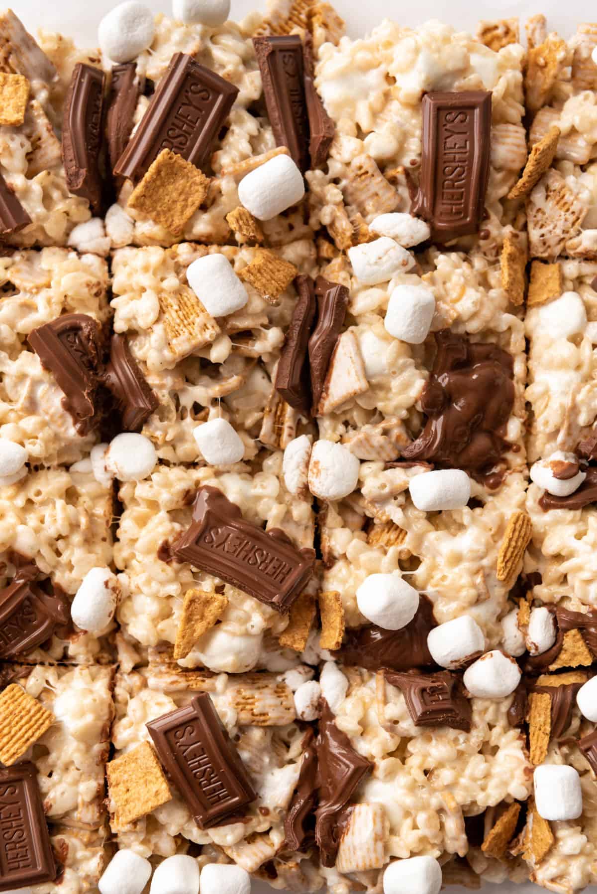 A close image of s'mores rice krispie treats with Hershey's bars on top.