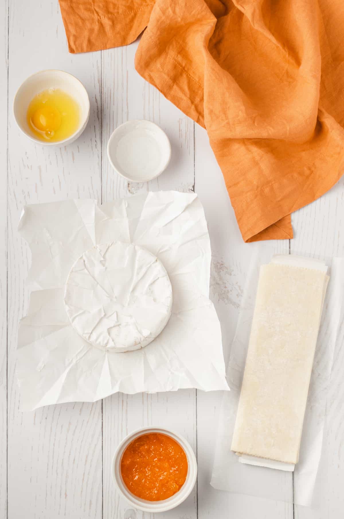 Overhead view of ingredients for baked brie