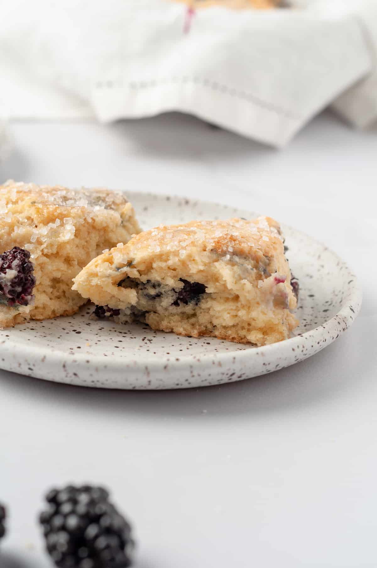 Two blackberry scones on plate