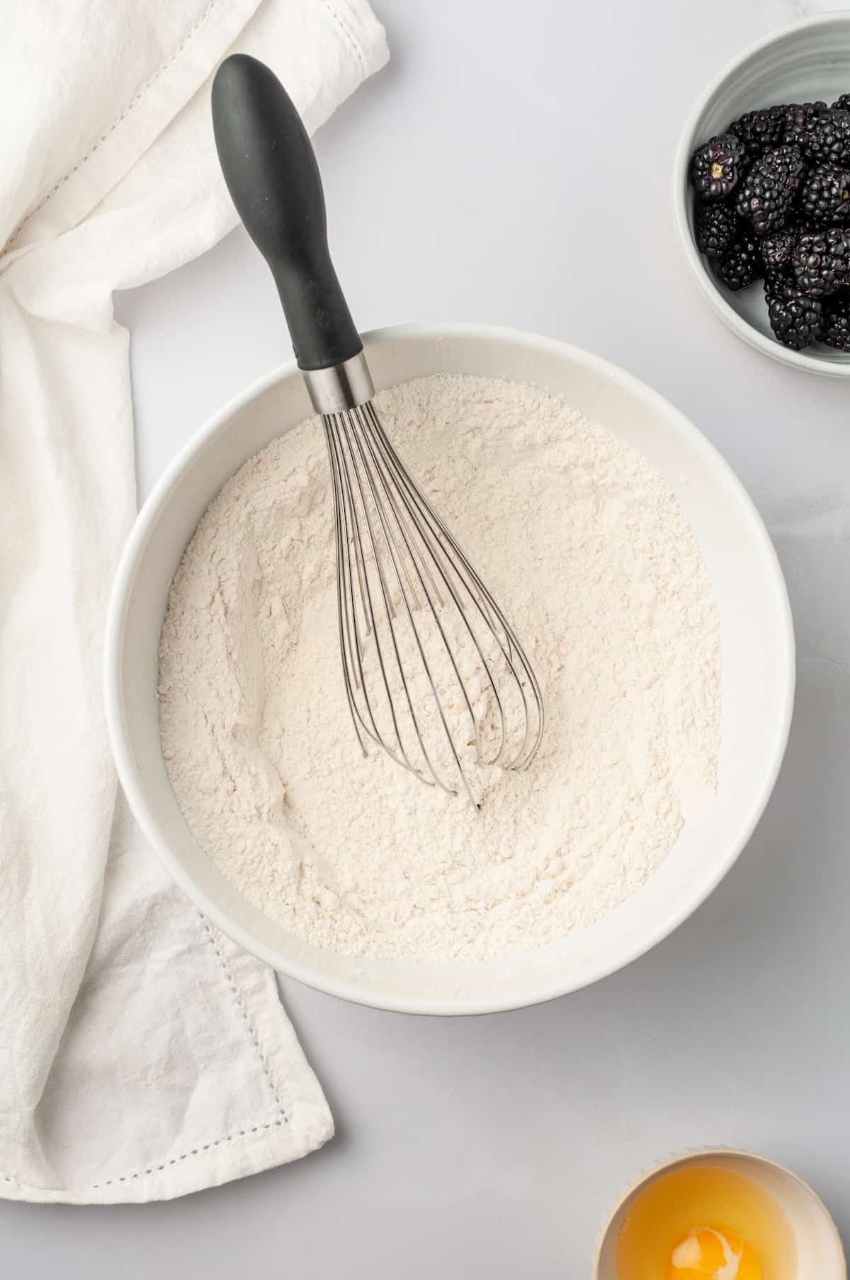 Bowl of dry scone ingredients with whisk