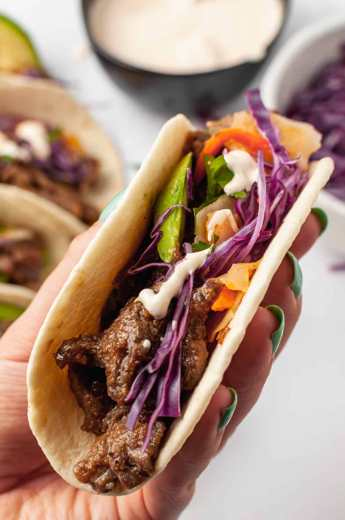 Hand holding a Korean beef taco