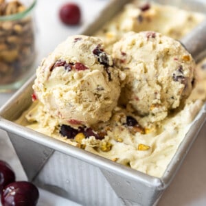 Scoops of cherry pistachio ice cream in a bread pan.