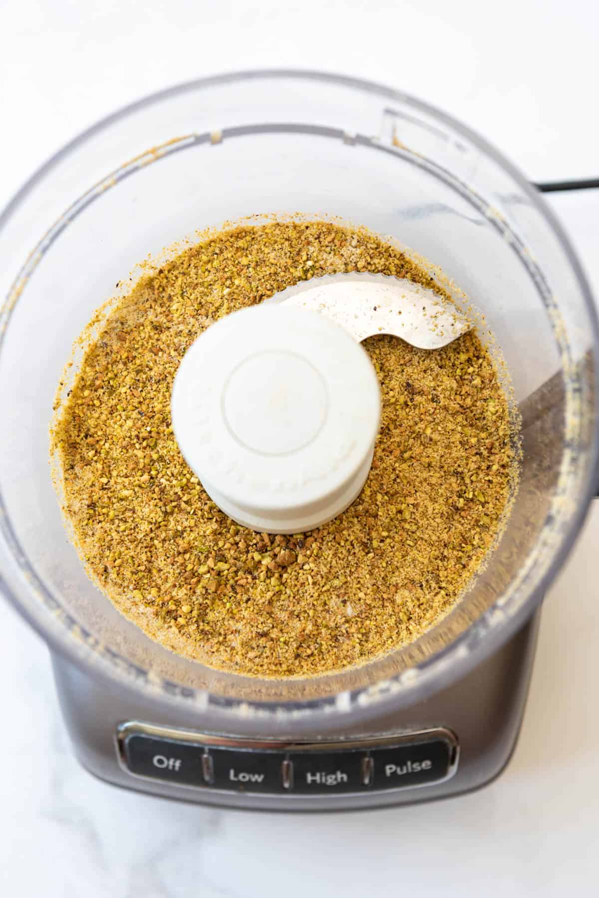Pistachios and sugar that have been pulsed in a food processor until finely ground.