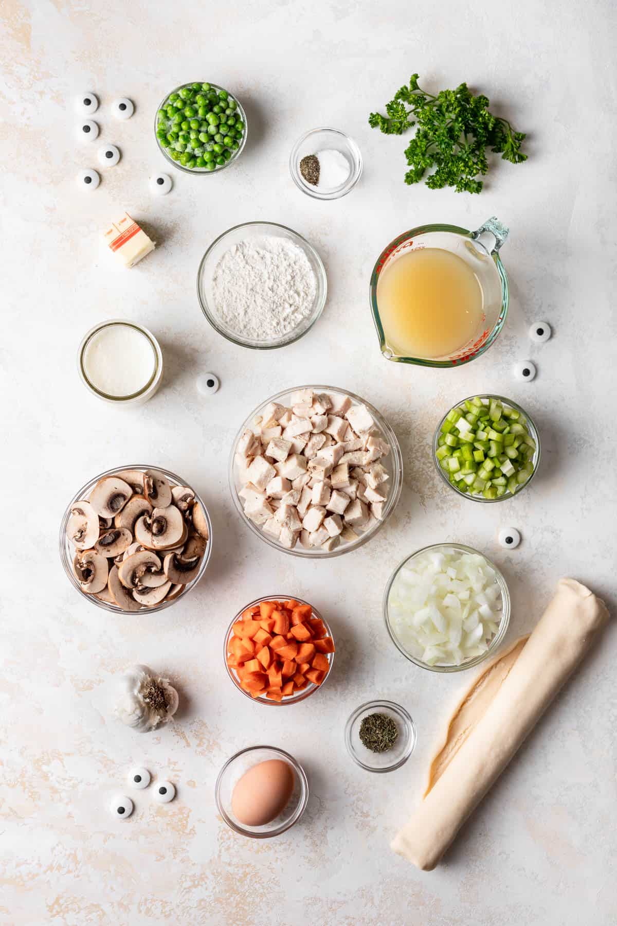 Ingredients for making individual mummy chicken pot pies in bowls.