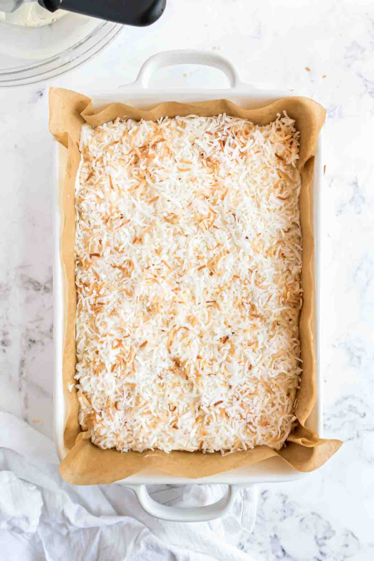 Coconut sugar cookie bars in a baking dish.