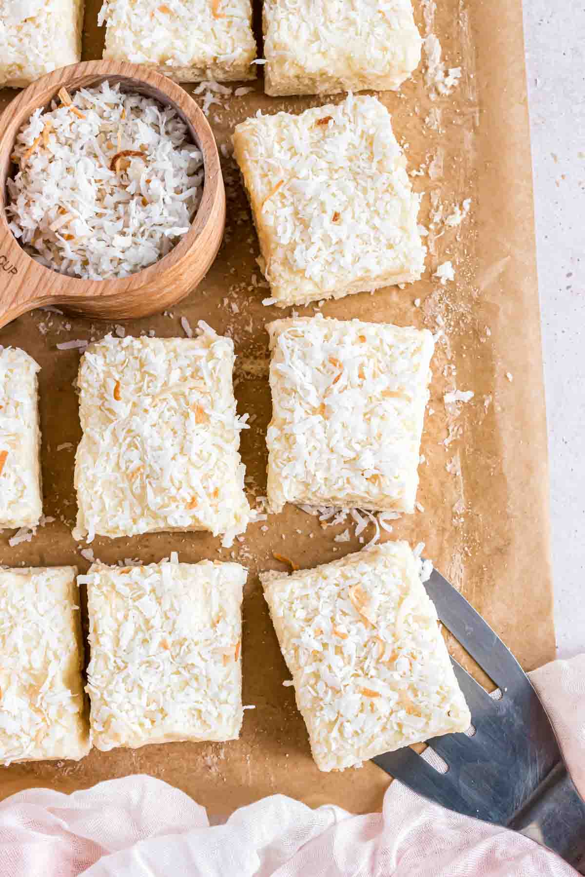 An overhead image of frosted coconut sugar cookie bars cut into squares.