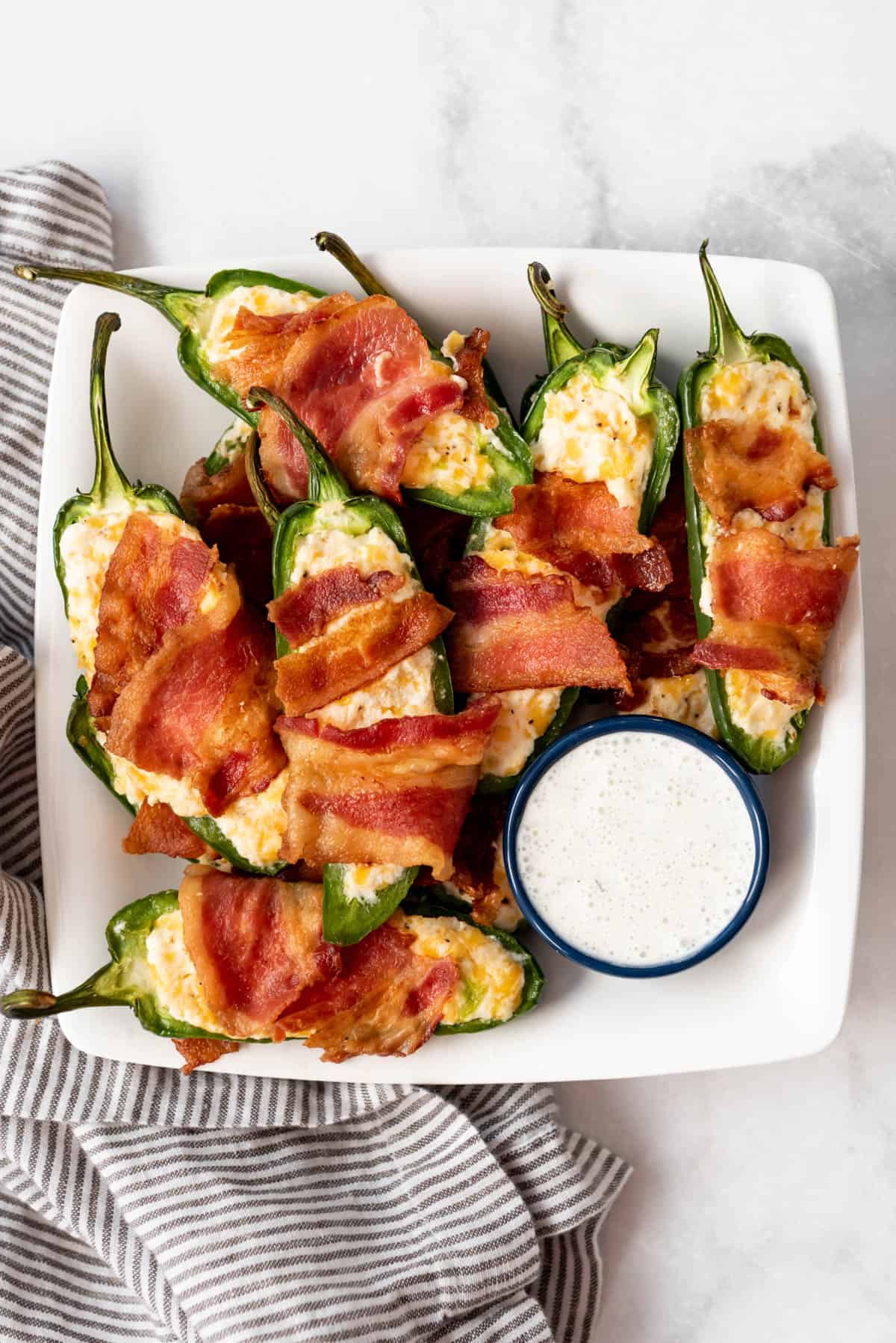 Jalapeno popper appetizers on a white plate.