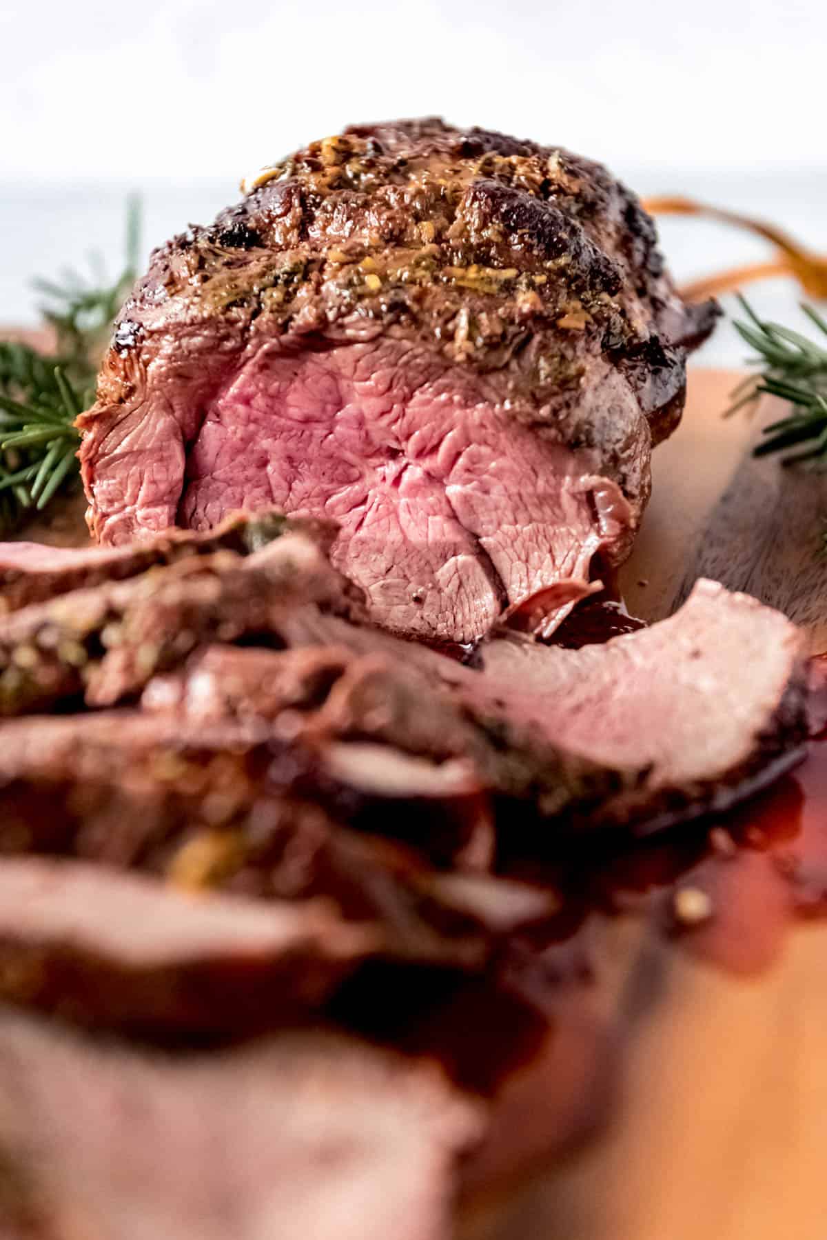 Close up of the rosy pink center of a medium cooked beef tenderloin roast.