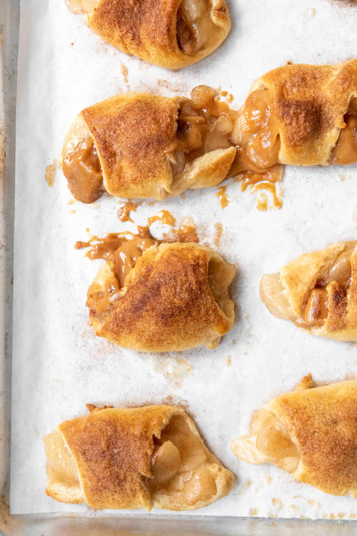 An overhead image of caramel apple pie crescent rolls sprinkled with cinnamon sugar.