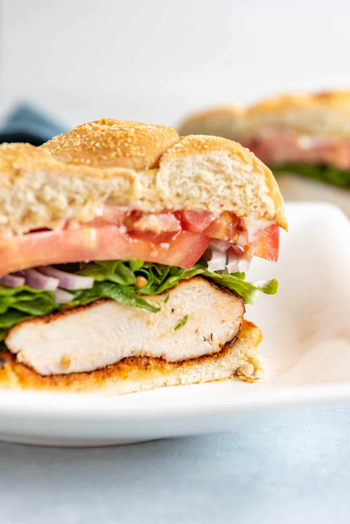 A sliced grilled Cajun chicken sandwich showing off the contents inside.