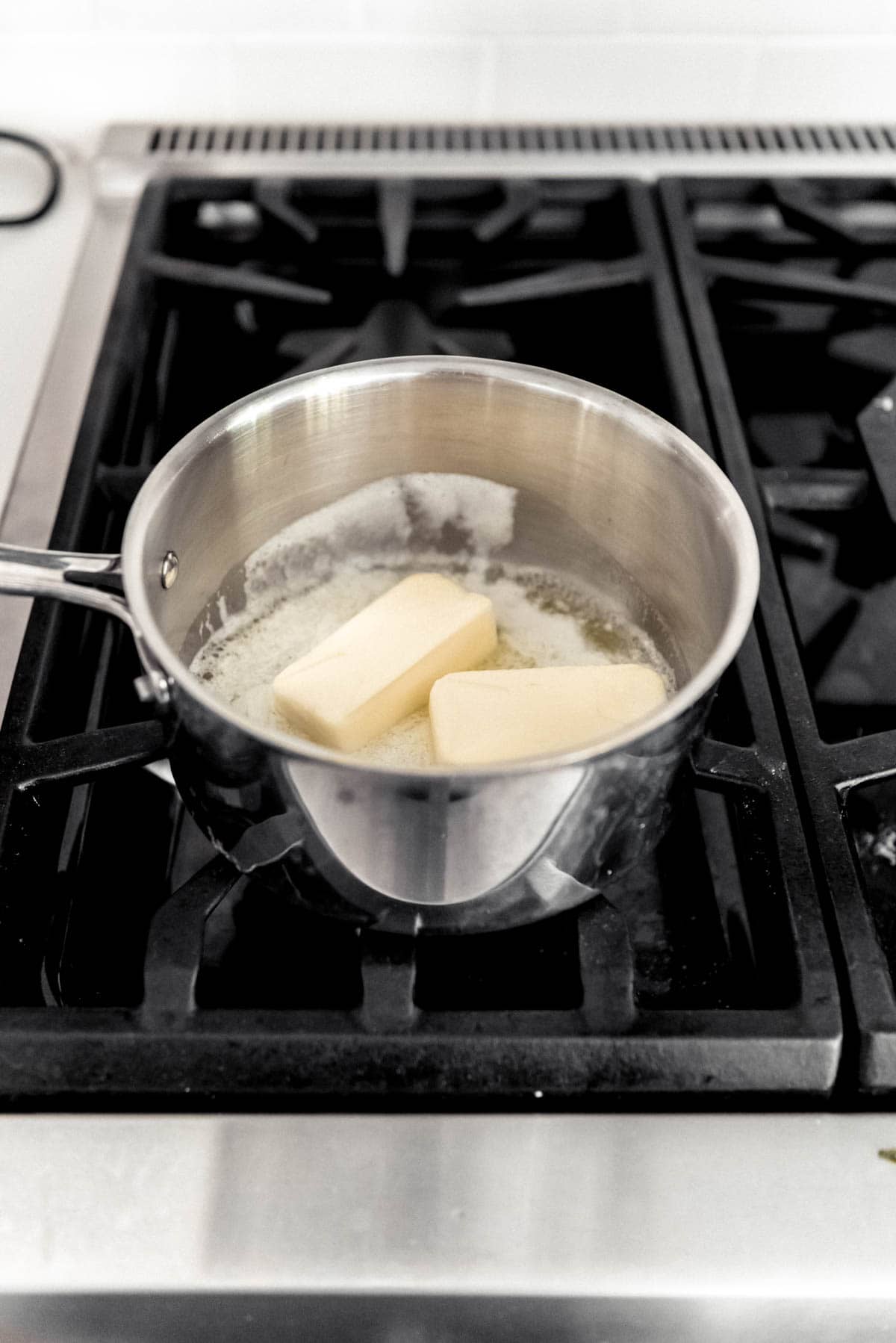 Melting butter in a saucepan on the stove.