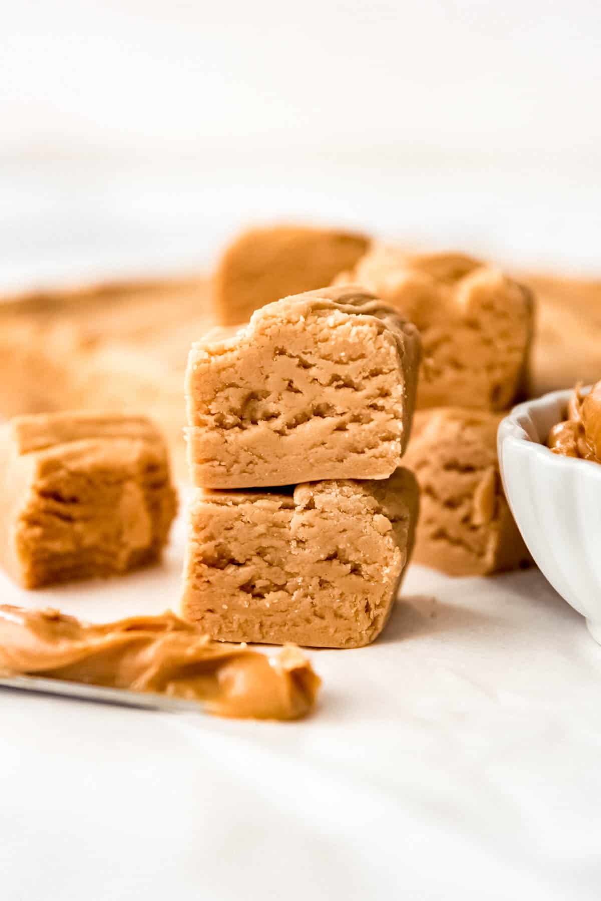 Close up of stacked squares of peanut butter fudge.