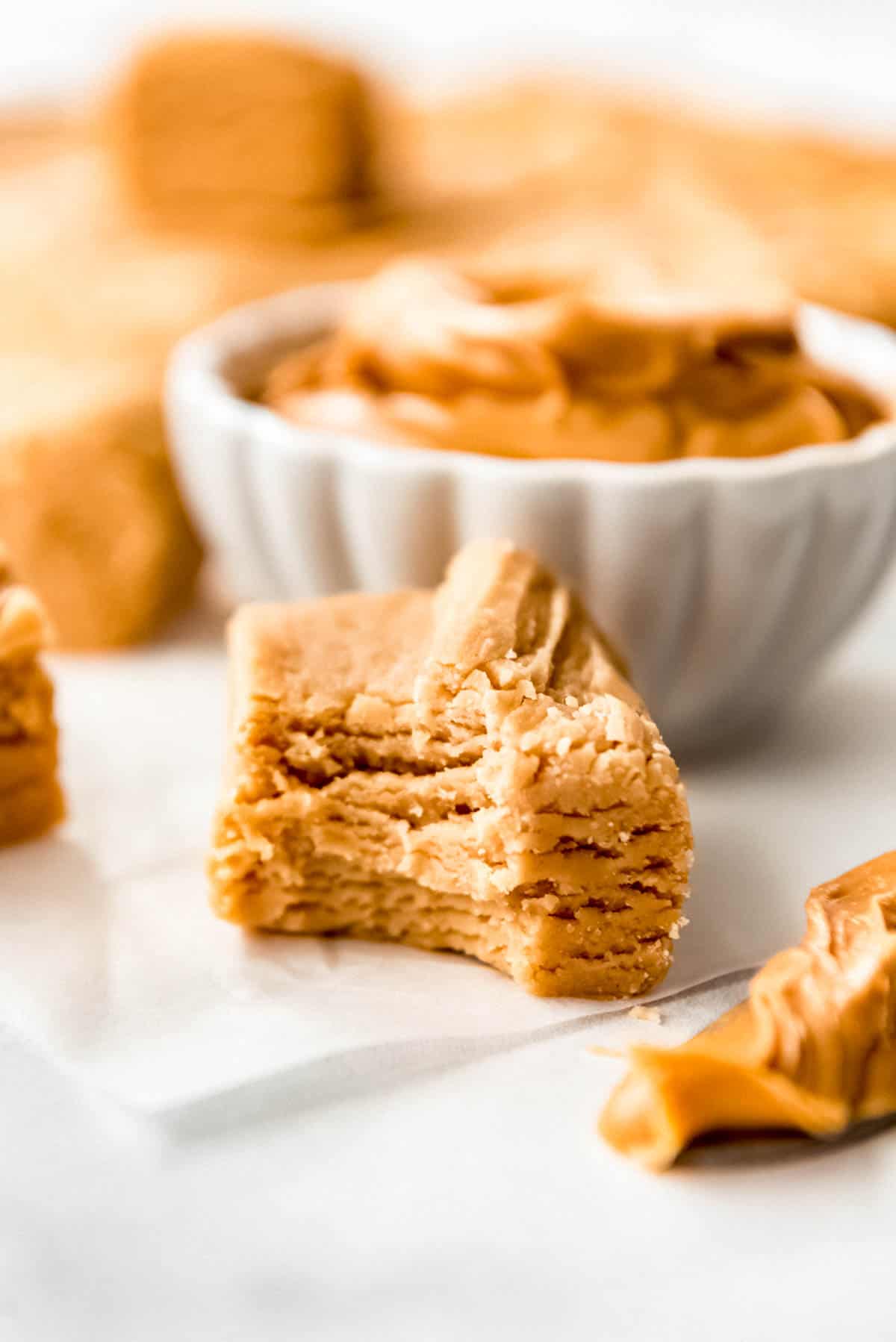 Close up of a piece of peanut butter fudge with a bite out of it.