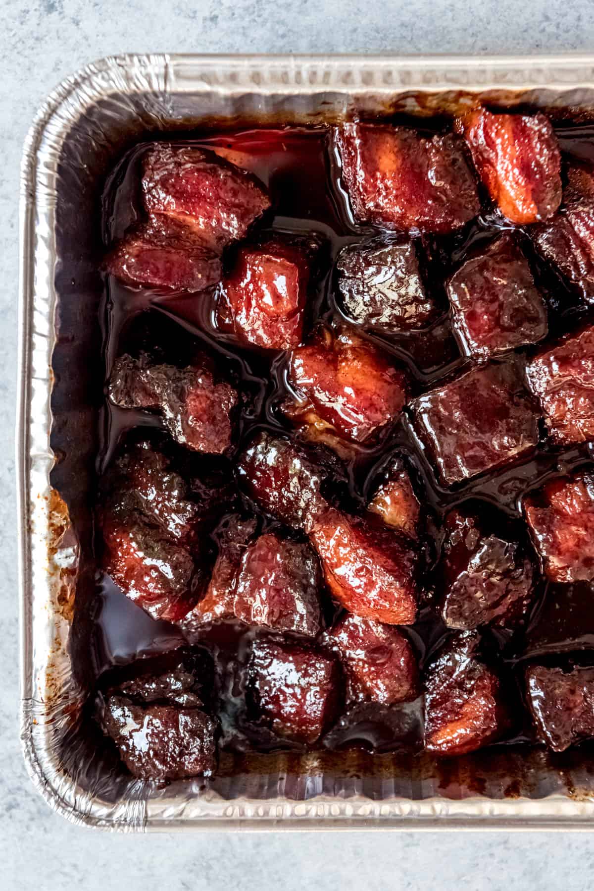 An image of smoked pork belly burnt ends in a sweet honey barbecue sauce.