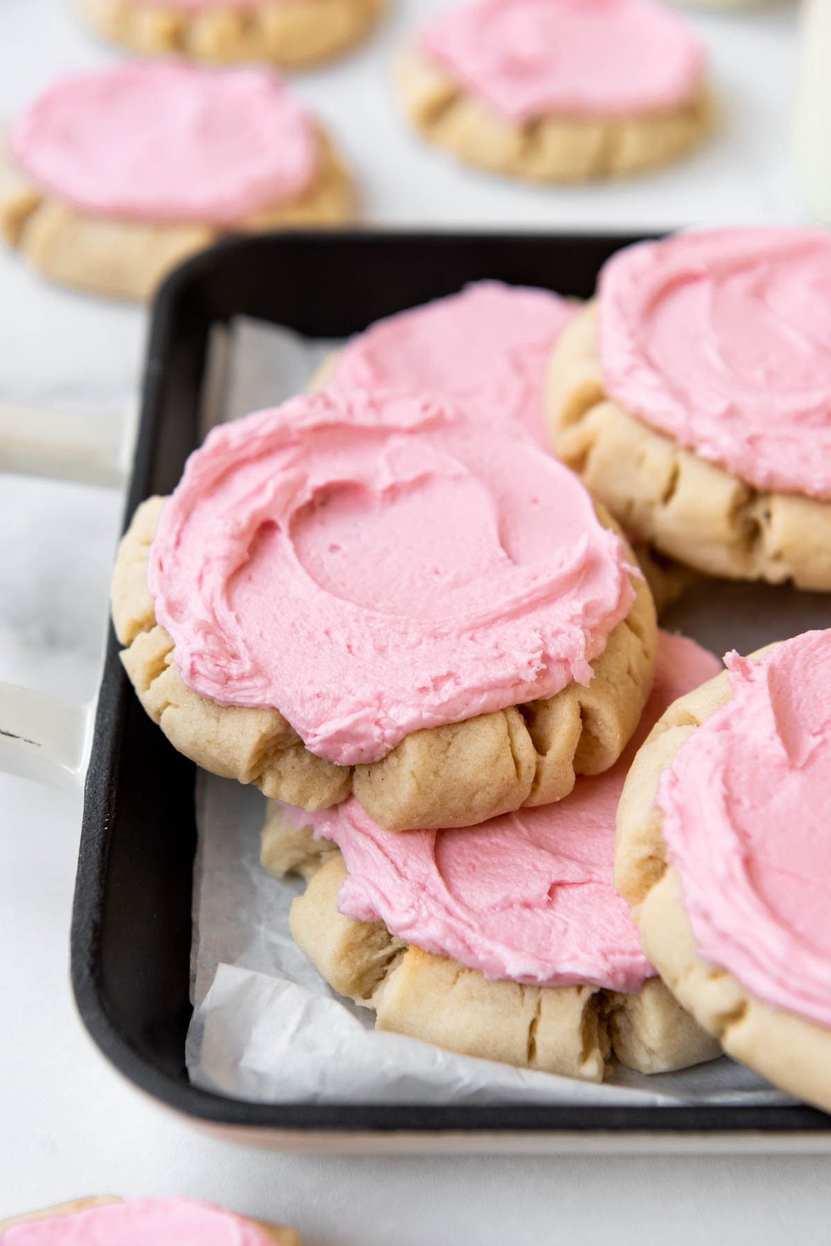 A black platter with copycat Swig sugar cookies with pink frosting arranged on it.