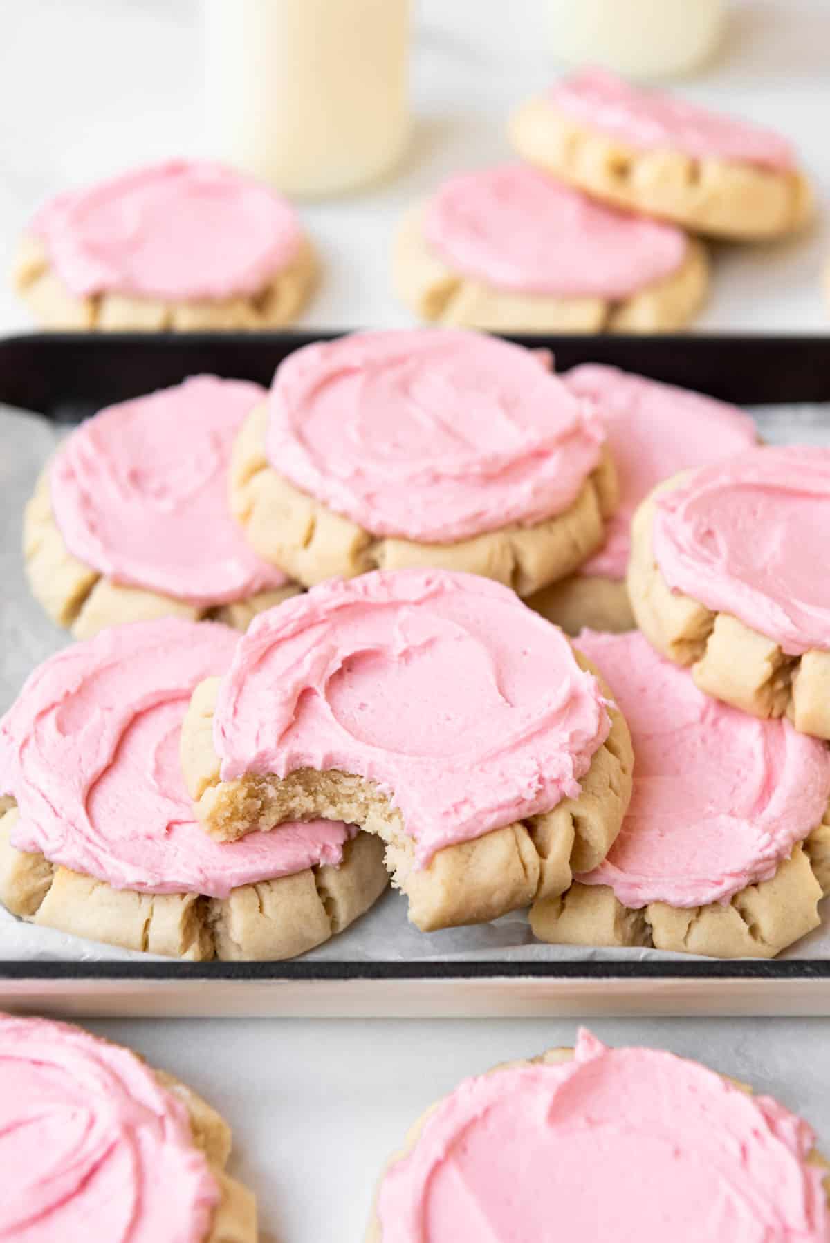 Stacked copycat Swig sugar cookies with pink frosting.