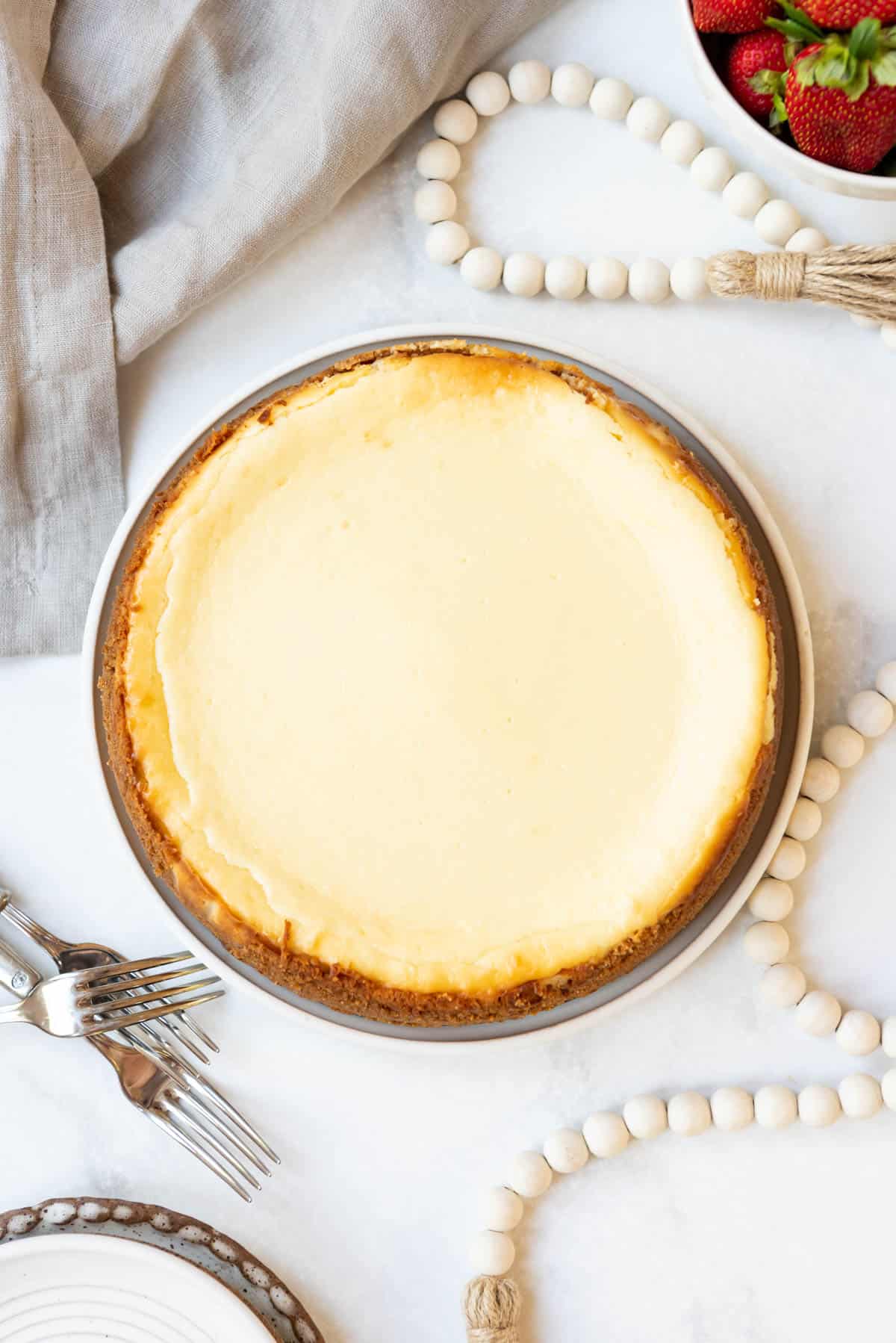 Top view of a freshly baked cheesecake in a springform pan. 